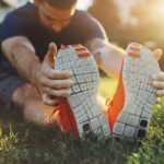 Man Stretching in Park