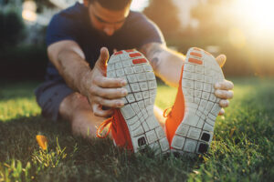 Man Stretching in Park